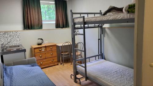 a bedroom with two bunk beds and a desk at Hostel Umbrella in Tallinn