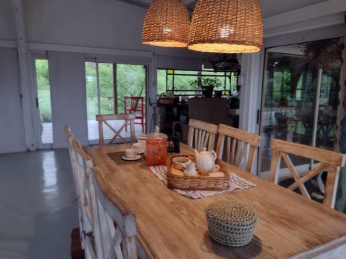 a dining room table with chairs and a wooden table with at LOFT DE MONTAÑA -LaS RABONAS - PISCINA EXCLUSIVA in Las Rabonas