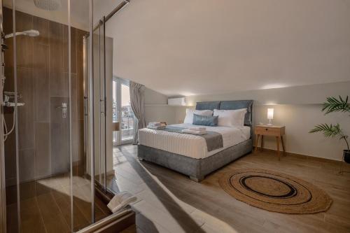 a bedroom with a bed and a glass shower at NK Luxury Apartments in Preveza