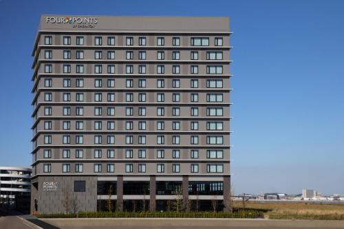 a tall gray building with many windows at Four Points by Sheraton Nagoya, Chubu International Airport in Tokoname