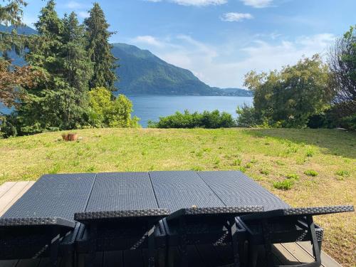 a picnic table with a view of a lake at Villa Rivabella - By Impero House in Ghiffa