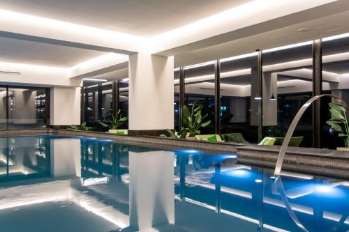 a swimming pool in a hotel with a building at Mexication Penthouse: Urban Retreat Col. American in Guadalajara