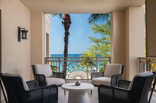 a patio with chairs and a table and a view of the ocean at The Ritz-Carlton, Grand Cayman in George Town