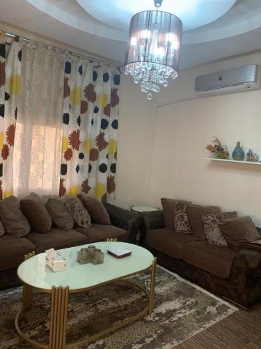a living room with a couch and a table at Ajloun 2 bedrooms apartment in Ajloun