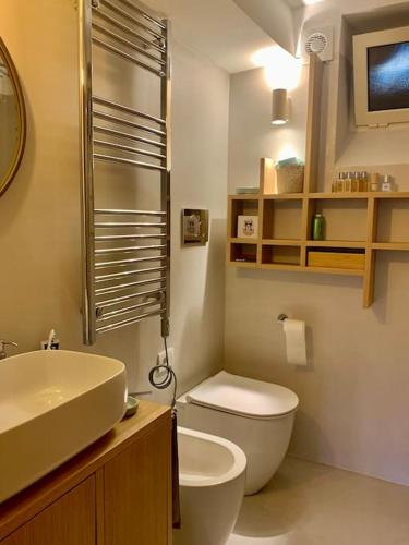 a bathroom with a white toilet and a sink at Miini loft di pregio a Roma Nord- Ponte Milvio in Rome