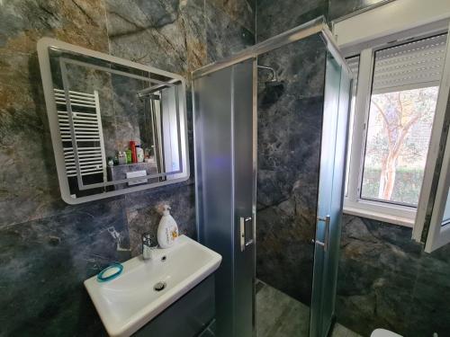 een badkamer met een wastafel en een douche bij Apartamento Famiglia vacanza in Mullini i Danit