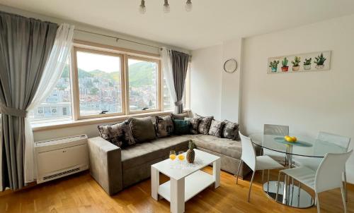 a living room with a couch and a table at Four Views Apartments in Budva