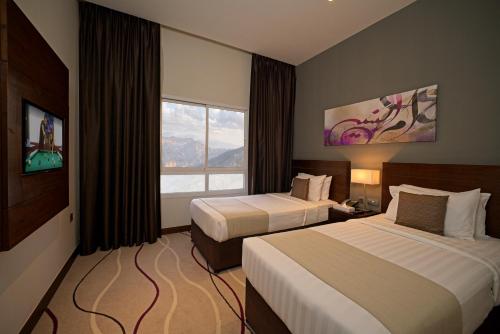 Postel nebo postele na pokoji v ubytování Action Hotel Ras Al Khaimah