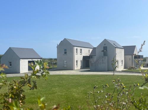 a row of houses in a field of grass at The Loft Curracloe, on Wexfords Coastal Scenic Route in Wexford