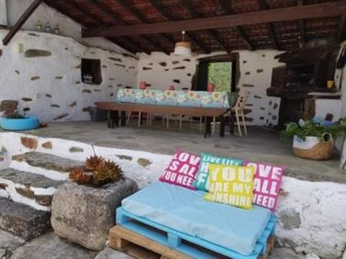 a room with a table and some pillows at A Cancela House Arouca Paiva Walkways in Lázaro
