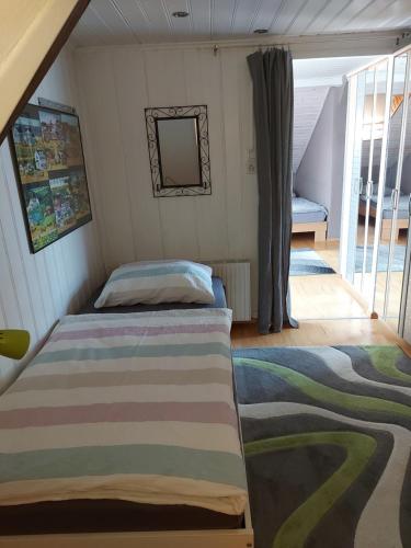 a bedroom with a bed and a balcony at Haus Basilea in Wolfhalden 