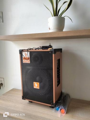 a speaker sitting on the floor under a shelf at Happiest Homestay 2 - Manor Crown Hue in Thôn Trường Giang