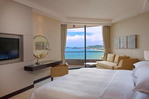 a hotel room with a bed and a view of the ocean at Sheraton Nha Trang Hotel & Spa in Nha Trang