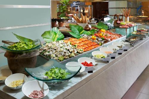 a buffet line with many different types of food at Sheraton Nha Trang Hotel & Spa in Nha Trang