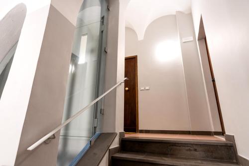 a stairway with a glass door and a stair case at La casa di Oliva in Macerata