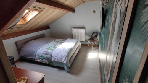 a small bedroom with a bed in a attic at Camp paradis in Vireux-Molhain