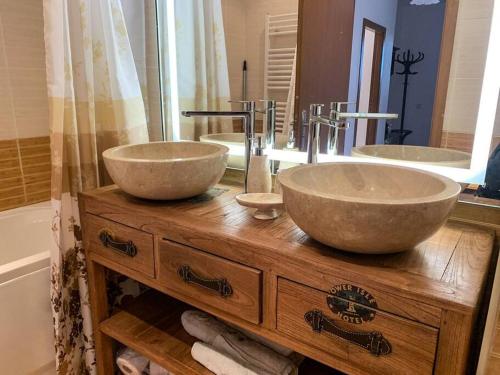 a bathroom with two sinks on top of a wooden table at 2 bedroom "Pine Hug" apartment in Borovets