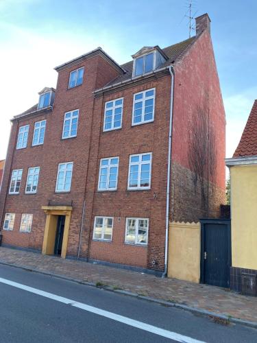 a red brick building on the side of a street at Udsigt Østersøen in Rønne