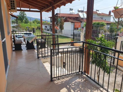 a balcony of a house with a table and chairs at Villa Sunny Day Riviera in Asprovalta