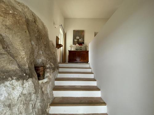 a staircase in a house with a stone wall at VENTOUX in Apt