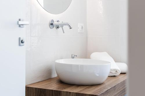a bathroom with a white sink and a mirror at Un Posto al Mare in Santa Maria di Castellabate