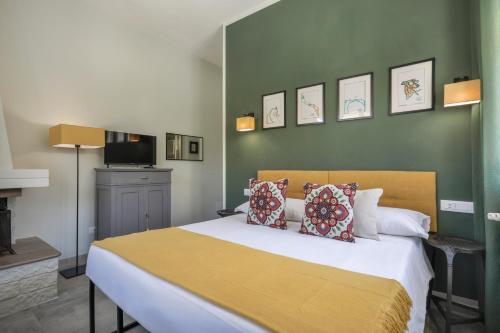 a bedroom with a large bed with two pillows at I Levrieri in Torre del Lago Puccini