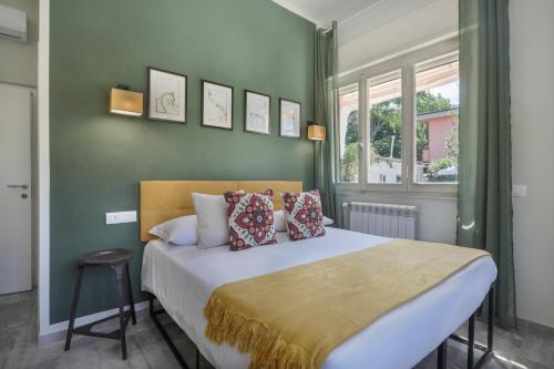 a bedroom with a large bed with pillows on it at I Levrieri in Torre del Lago Puccini
