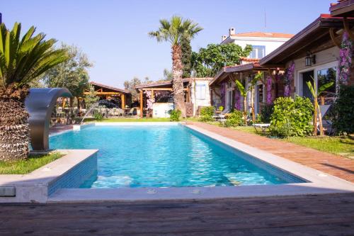 a swimming pool in the backyard of a house at Etiz Hotels Alaçatı in Cesme