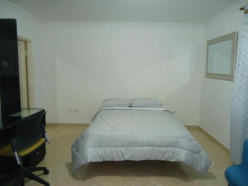 a bedroom with a bed and a chair in it at Habitación privada in Neiva