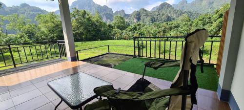 a balcony with a table and chairs and a view at Phu Siab Mhok@KhaoSok in Khao Sok