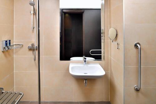 a bathroom with a sink and a shower at Four Points By Sheraton Nairobi Hurlingham in Nairobi