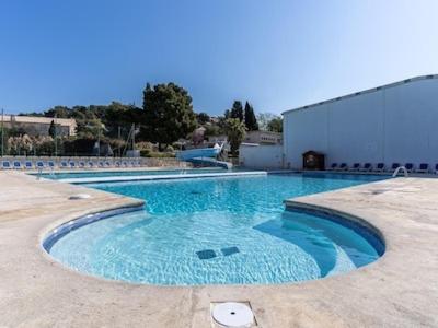 une grande piscine avec de l'eau bleue dans l'établissement appartement dans résidence avec piscine, à La Londe-les-Maures
