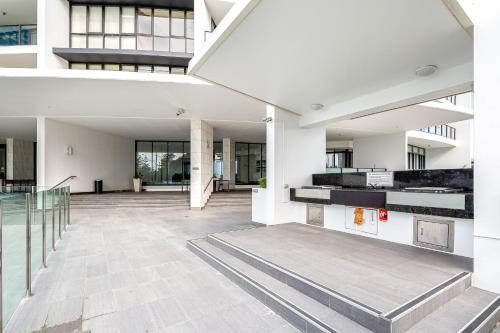 an empty lobby of a building with a staircase at Sierra Grand Apartments - Hosted by Wow Stay in Gold Coast