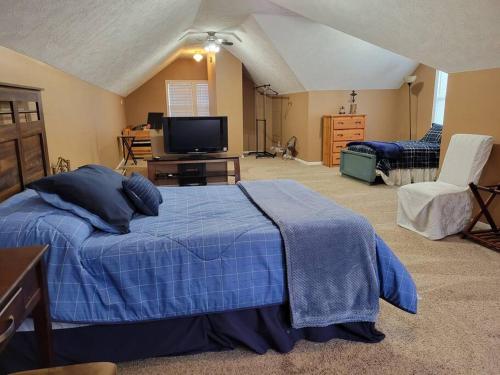 a bedroom with a bed and a flat screen tv at Home near Zoo/College World Series/Downtown in Omaha