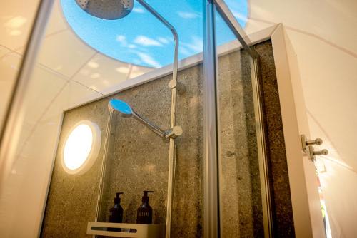 a bathroom with a shower with bottles in it at Astral Tulum in Tulum
