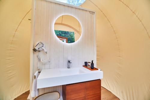 a bathroom with a sink and a mirror at Astral Tulum in Tulum