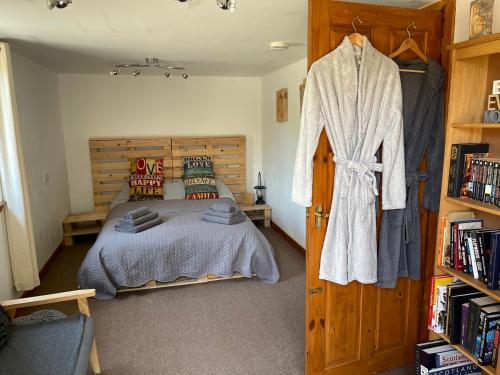 a bedroom with a bed and a wooden door at Yairbrig Holiday in Galashiels