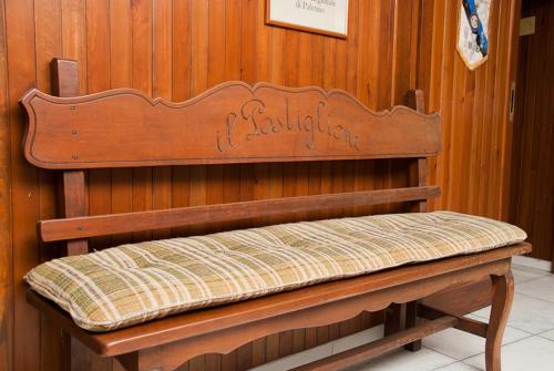 a bench in a room with a wooden wall at Hotel Del Postiglione in Ischia