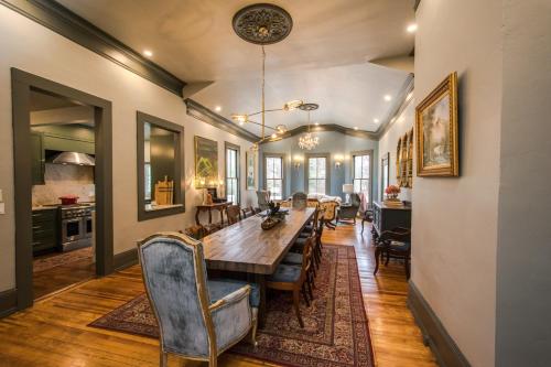 a dining room with a long table and chairs at Casa Carolina Estate in Hendersonville