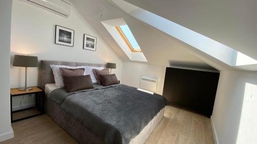 a bedroom with a large bed in a attic at NATURAvistaMARE I in Dziwnów