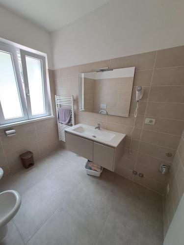 a bathroom with a sink and a mirror at Appartamenti Elisabeth in Brenzone sul Garda