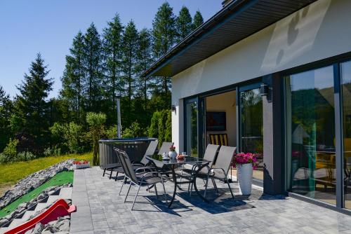 a patio with chairs and a table on a patio at Domek Veron in Wysowa-Zdrój