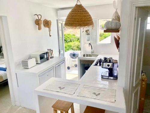 a kitchen with a counter with a coffee maker on it at Castell Sol - Arenal Den Castell in Arenal d'en Castell