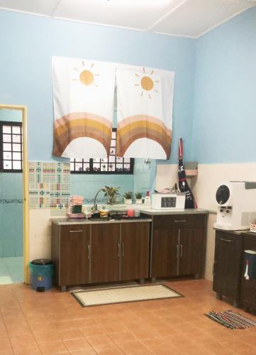 a kitchen with a sink and two sun shades at E&Y Inn in Kampong Tanjong Tengku