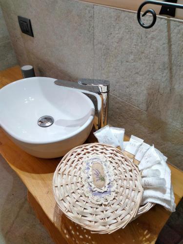 a bathroom with a sink and a white bowl at Il posto al sole in Teglio
