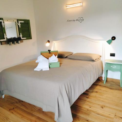 a bedroom with a large bed with two pillows at Il posto al sole in Teglio