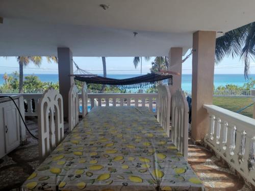 a walkway to the beach with a tent and the ocean at Villa Rosa in Bejuquero