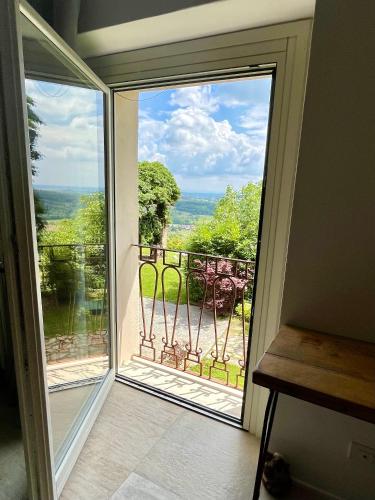 a sliding glass door with a view of a balcony at Cascina Voglietti in Murisengo