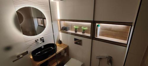 a small bathroom with a sink and a mirror at A&A Luxury Apartments Preveza in Preveza