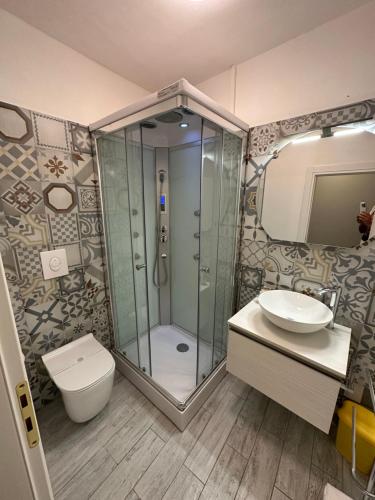 a bathroom with a shower and a toilet and a sink at ANTICA DIMORA DEL BORGO Luxury TUSCANY in Bibbiena